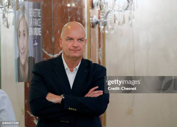 Thierry Legier a bodyguard to French far-right political party National Front leader Marine Le Pen stands guard, during a press conference focused on...