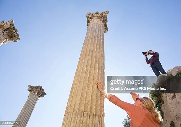 man and woman explore ruins, with camera - ephesus 個照片及圖片檔