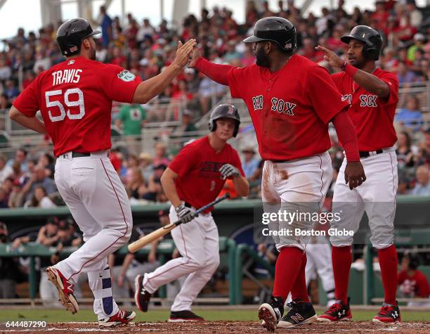 Boston Red Sox first baseman Sam Travis is congratulated by Boston Red Sox third baseman Pablo Sandoval and Boston Red Sox outfielder Chris Young who...