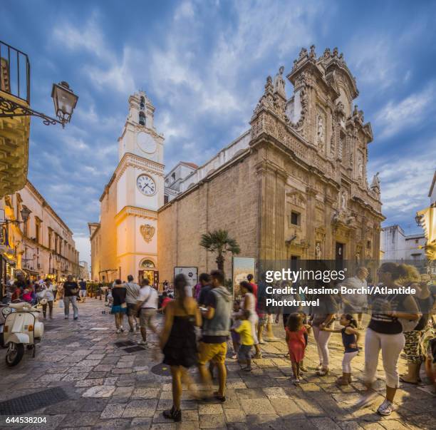 people near the basilica concattedrale (cathedral, duomo) di sant'agata - salento apulia stock pictures, royalty-free photos & images