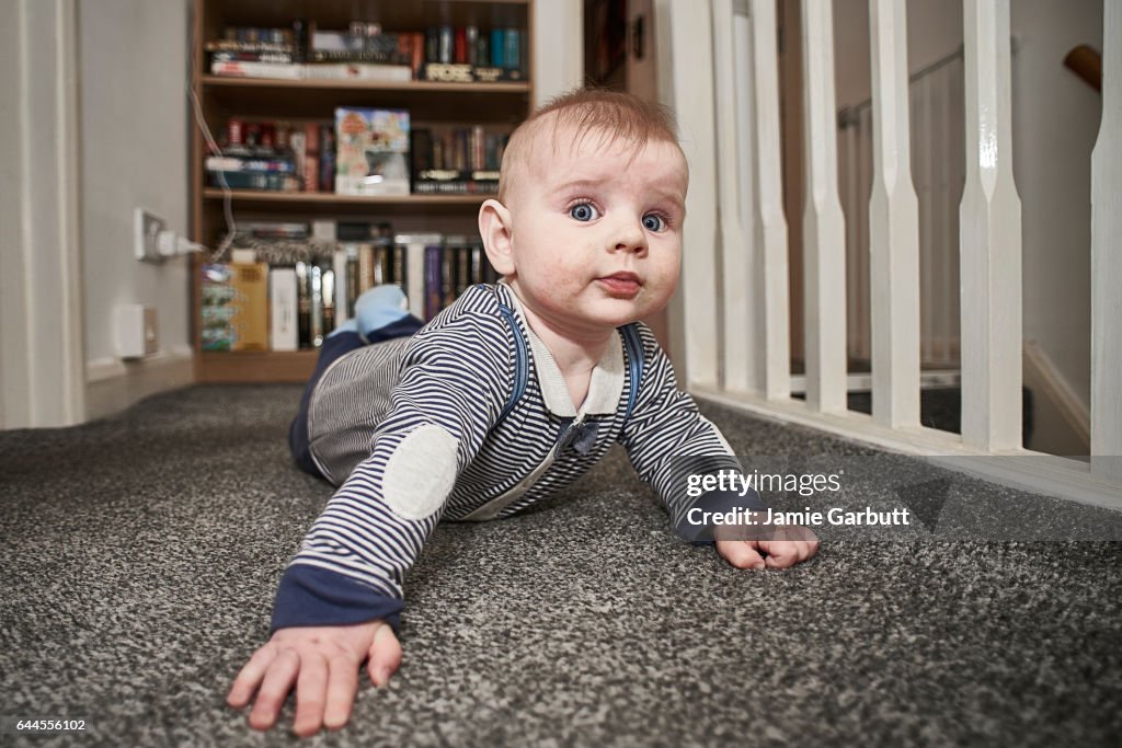 A 7 month old baby looking at the camera