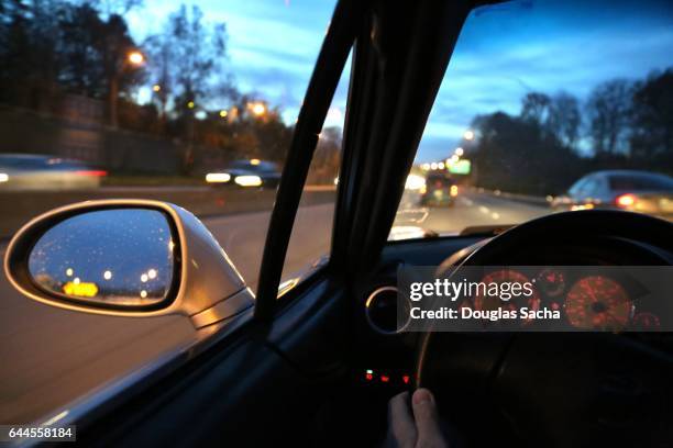 dashboard view of a moving vehicle at dawn - viewfinder stockfoto's en -beelden