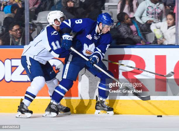 Travis Dermott of the Toronto Marlies controls the puck past Erik Condra of the Syracuse Crunch during AHL game action on February 22, 2017 at Ricoh...