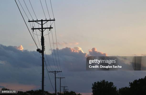 low voltage power lines connecting residential neighborhoods to the power grid - power line stock pictures, royalty-free photos & images