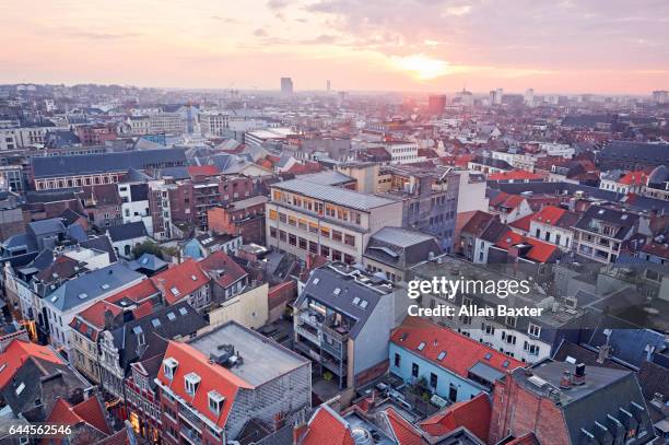 aerial view of the rooftops of ghent at sunset - ghent belgium stock pictures, royalty-free photos & images