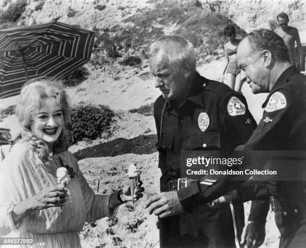 Actress Bette Davis as Baby Jane Hudson and actors Russ Conway and James Seay in a publicity still for the Warner Bros film 'What Ever Happened to...