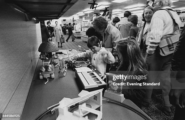 Shoppers at a branch of the British Home Stores department store chain on the ground floor of the former Derry & Toms building on Kensington High...