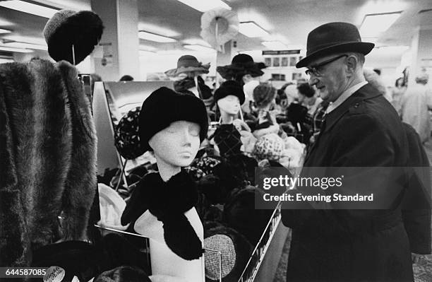 Shoppers at a branch of the British Home Stores department store chain on the ground floor of the former Derry & Toms building on Kensington High...