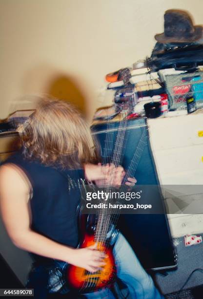 teenage boy playing bass guitar - heavy metal stock pictures, royalty-free photos & images