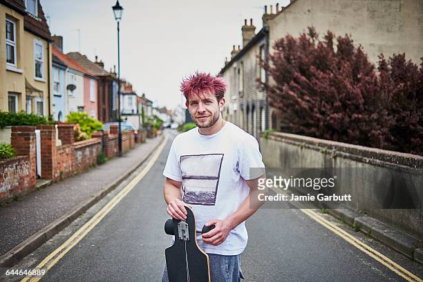 street portrait of a long boarder in the street - hair color stock-fotos und bilder