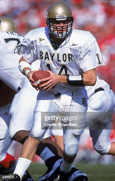 Quarterback Guy Tomchek of the Baylor Bears scrambles with the ball during the game against the Nebraska Cornhuskers at the Memorial Stadium in...