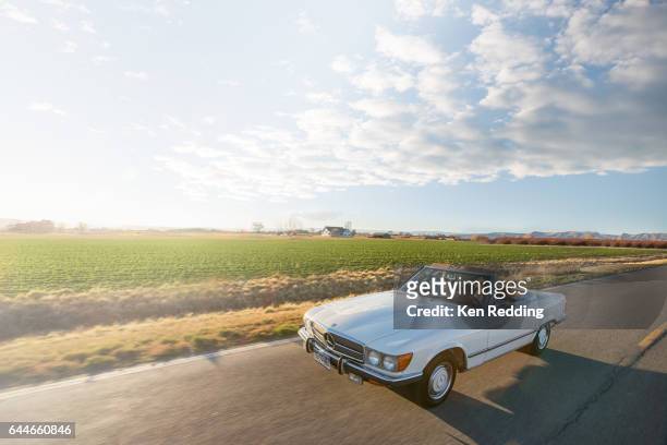 2 ladies driving in a vintage convertible - oldtimer stock-fotos und bilder