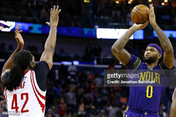 DeMarcus Cousins of the New Orleans Pelicans shoots over Nene Hilario of the Houston Rockets during the first half of a game at the Smoothie King...