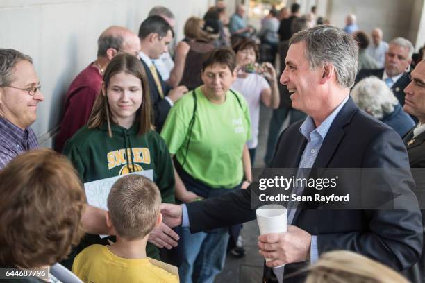 Rep. Tom Rice, right, greets people waiting in line before a town hall meeting at the Florence County Library on February 23, 2017 in Florence, South...