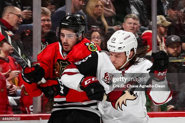 Ryan White of the Arizona Coyotes hits Nick Schmaltz of the Chicago Blackhawks in the first period at the United Center on February 23, 2017 in...