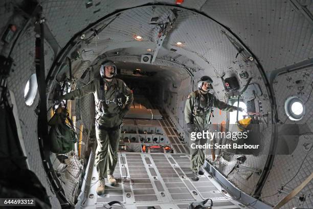 Two Royal Australian Air Force Loadmasters look on in the back of C-27 J Spartan as they fly during a media preview ahead of the Australian...