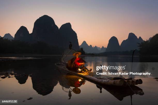 cormorant fisherman on li river, yangshuo, china - tribal head gear in china stock pictures, royalty-free photos & images