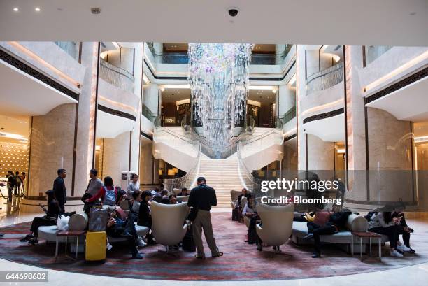 Visitors sit in a lobby at the Galaxy Macau Phase 2 casino and hotel, developed by Galaxy Entertainment Group Ltd., in Macau, China, on Wednesday,...