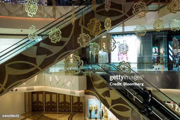 Visitors ride an escalator at the Galaxy Macau Phase 2 casino and hotel, developed by Galaxy Entertainment Group Ltd., in Macau, China, on Wednesday,...