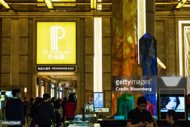 Visitors walk through the Promenade East shopping area at the Galaxy Macau Phase 2 casino and hotel, developed by Galaxy Entertainment Group Ltd., in...