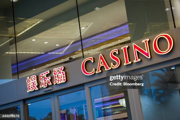 Signage for casino is displayed atop an entrance at the Galaxy Macau casino and hotel, developed by Galaxy Entertainment Group Ltd., in Macau, China,...