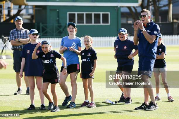 Thirteen-year-old Erin Buckland who is 'flying the flag' for females in cricket enjoys a laught with teammates and Mitchell Santner of New Zealand...