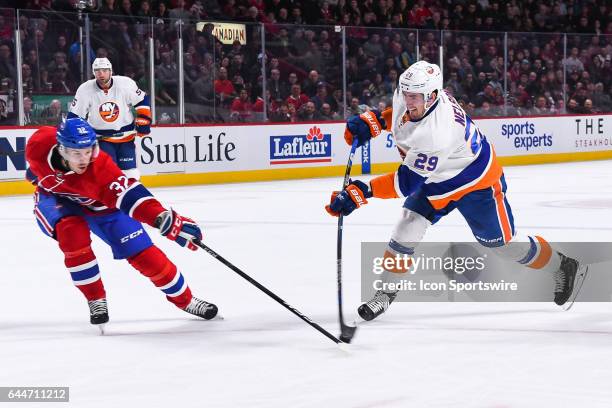 Montreal Canadiens Winger Brian Flynn tries so stop New York Islanders Left Wing Brock Nelson from shooting during the New York Islanders versus the...