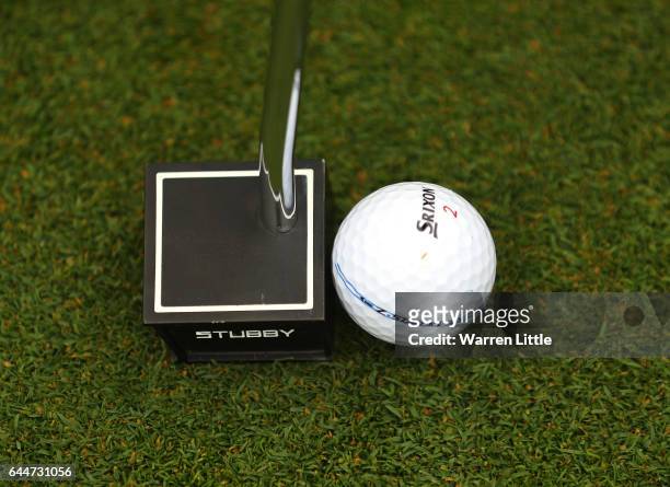 Jaco Van Zyl of South Africa putts with his new small square headed putter during completion of the rain delayed first round of the Joburg Open at...