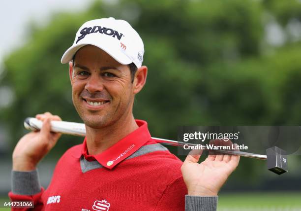 Jaco Van Zyl of South Africa poses with his new small square headed putter during completion of the rain delayed first round of the Joburg Open at...