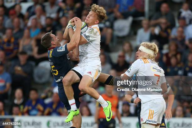 Ben Smith of the Highlanders and Damian McKenzie of the Chiefs compete for high ball during the round one Super Rugby match between the Highlanders...