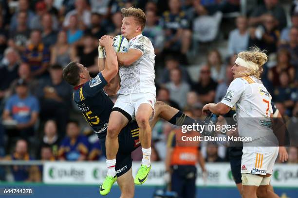 Ben Smith of the Highlanders and Damian McKenzie of the Chiefs compete for high ball during the round one Super Rugby match between the Highlanders...