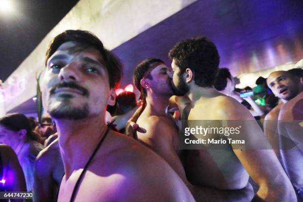 Revelers kiss at the 'LED is My Light' street party in the early morning hours at the beginning of Carnival on February 24, 2017 in Rio de Janeiro,...