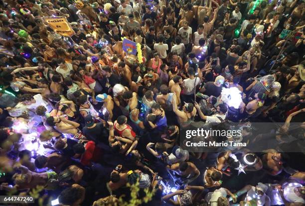 Revelers celebrate at the 'LED is My Light' street party in the early morning hours at the beginning of Carnival on February 24, 2017 in Rio de...