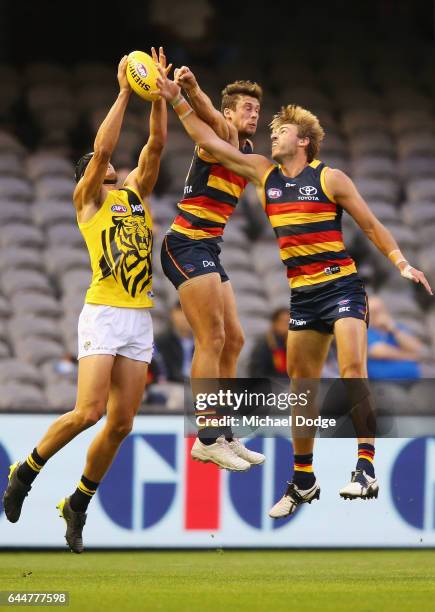 Ben Griffiths of the Tigers compete for the ball against Luke Brown and Daniel Talia of the Crows during the JLT Community Series AFL match between...