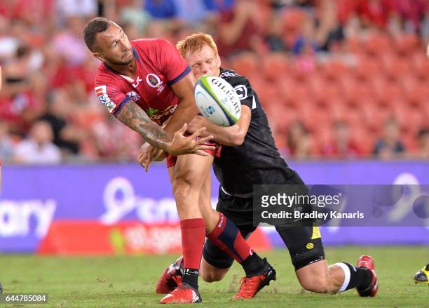 Reds player Quade Cooper gets a ball away during the round one Super Rugby match between the Reds and the Sharks at Suncorp Stadium on February 24,...