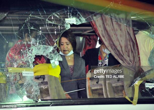 Leila de Lima the Philippine Justice Secretary and head of the panel of investigators on the deadly hostage-taking, stands inside the tourist bus...