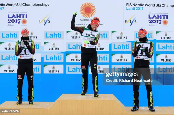 Silver medalist Eric Frenzel of Germany, gold medalist Johannes Rydzek of Germany and bronze medalist Bjoern Kircheisen of Germany celebrate...