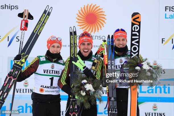 Silver medalist Eric Frenzel of Germany, gold medalist Johannes Rydzek of Germany and bronze medalist Bjoern Kircheisen of Germany celebrate...