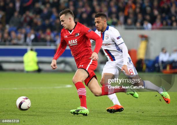 Mats Seuntjens of AZ Alkmaar and Corentin Tolisso of Lyon in action during the UEFA Europa League Round of 32 second leg match between Olympique...