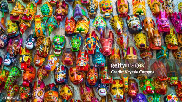 carved mayan masks for sale in antigua, guatemala - mask culture stock-fotos und bilder