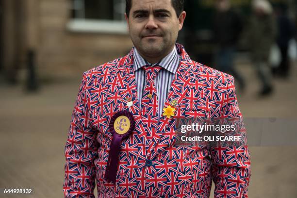 Independence Party member Mark Childs wears a party rosette on a Union Flag suit outside the campaign office for UKIP Leader Paul Nuttall following...