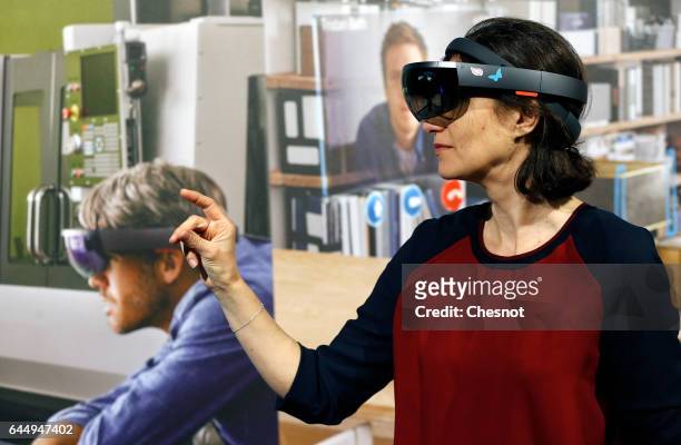 Visitor tries a virtual reality headset Microsoft HoloLens during the show "Virtuality Paris 2017" on February 24, 2017 in Paris, France. Microsoft...