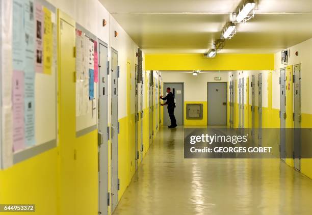Guard closes a door in a hallway of cells at Mont-de-Marsan prison, in Mont-de-Marsan, on January 26, 2017. The prison was chosen as the site to test...