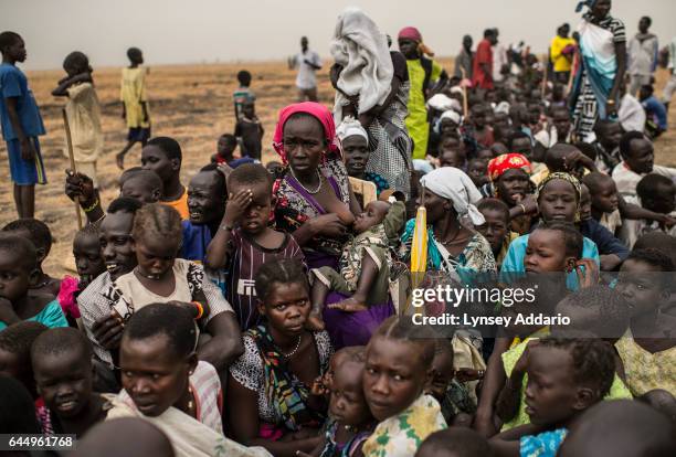 Tens of thousands of South Sudanese people line up to register for a food distribution administered by the International Committee of the Red Cross...