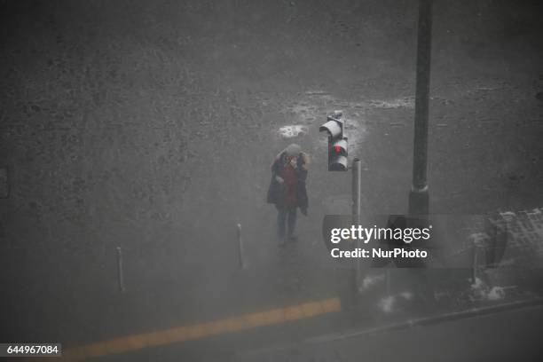 People are seen in the streets of Bydgoszcz, Poland during heavy snowfall on 24 February, 2017.