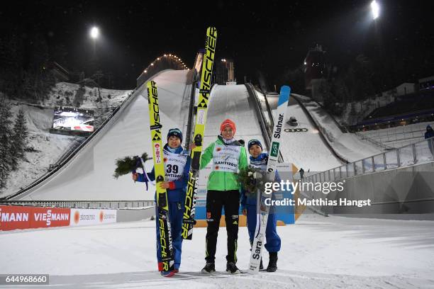 Silver medalist Yuki Ito of Japan, gold medalist Carina Vogt of Germany and bronze medaliist Sara Takanashi of Japan celebrate following the Women's...