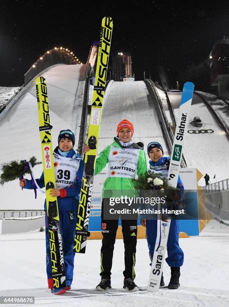 Silver medalist Yuki Ito of Japan, gold medalist Carina Vogt of Germany and bronze medaliist Sara Takanashi of Japan celebrate following the Women's...