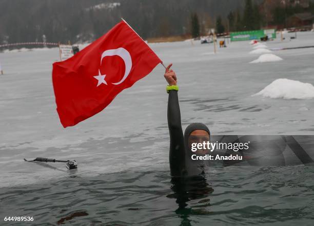 Turkish free diver Derya Can Gocen celebrates as she holds a Turkish flag after breaking a new world record with a 120-meter horizontal dive in the...