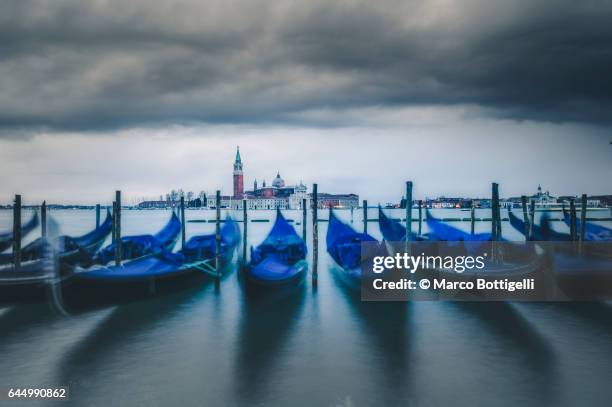 moored gondolas in riva degli schiavoni. venice, italy - riva stockfoto's en -beelden