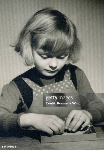 girl of five playing. switzerland in the 1940's. - 1940 1949 foto e immagini stock